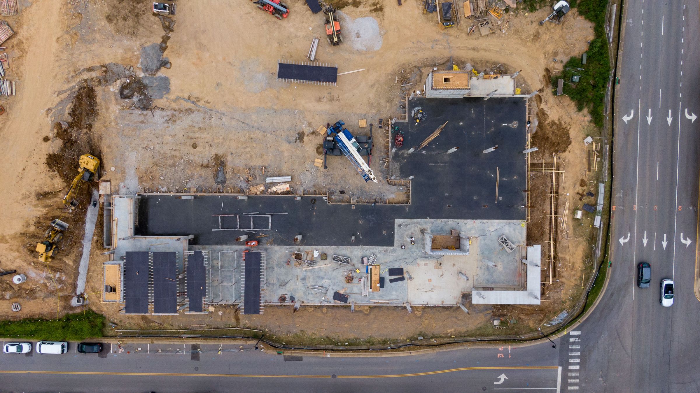 Nadir aerial view of a commercial construction site under slab and framing work